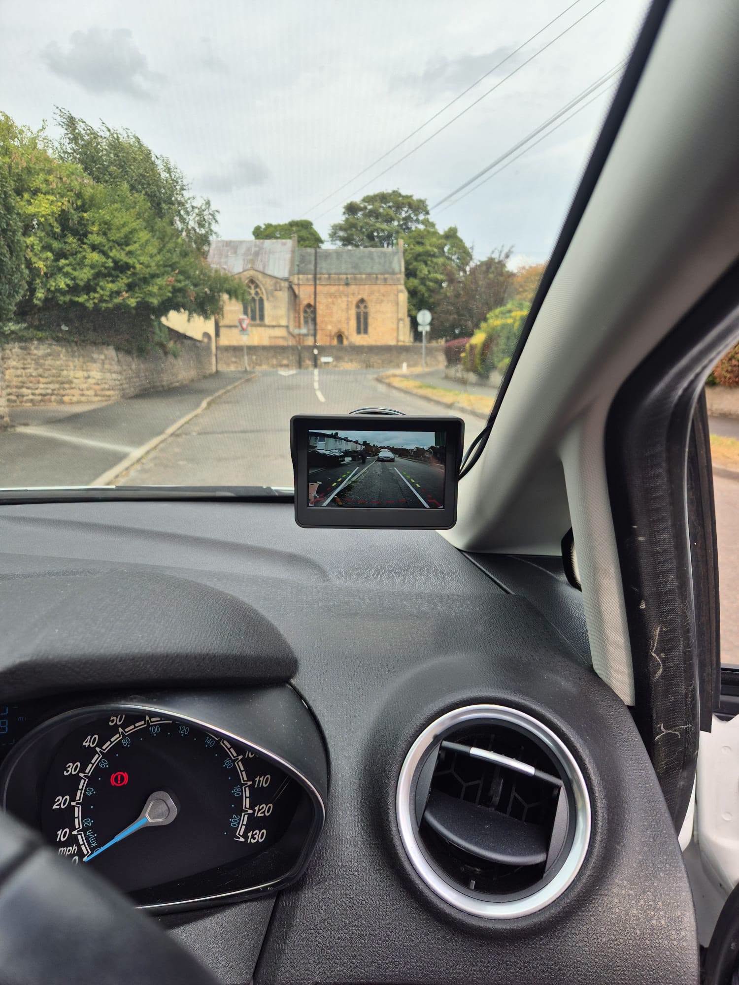 Small dashboard screen showing a rear camera view